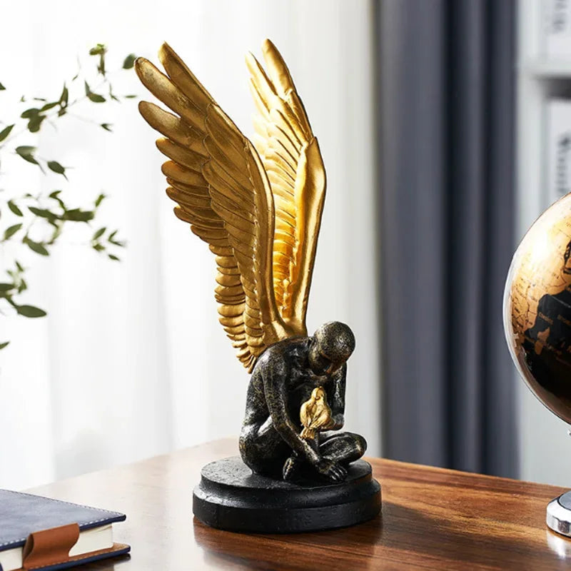 Angel Wings statue in dark resin with golden wings on black base on Tampa Home & Garden Store