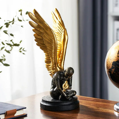 Angel Wings statue in dark resin with golden wings on black base on Tampa Home & Garden Store