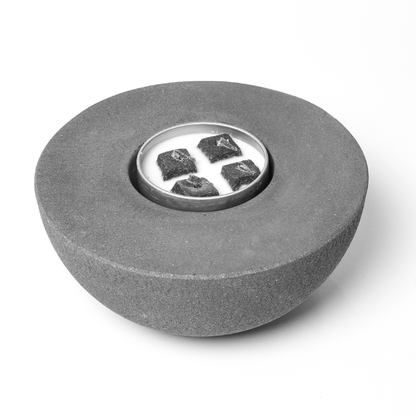 Concrete gray semi-round outdoor fire pit City Bonfires with metal inset candle and black rocks on Tampa Home & Garden Store
