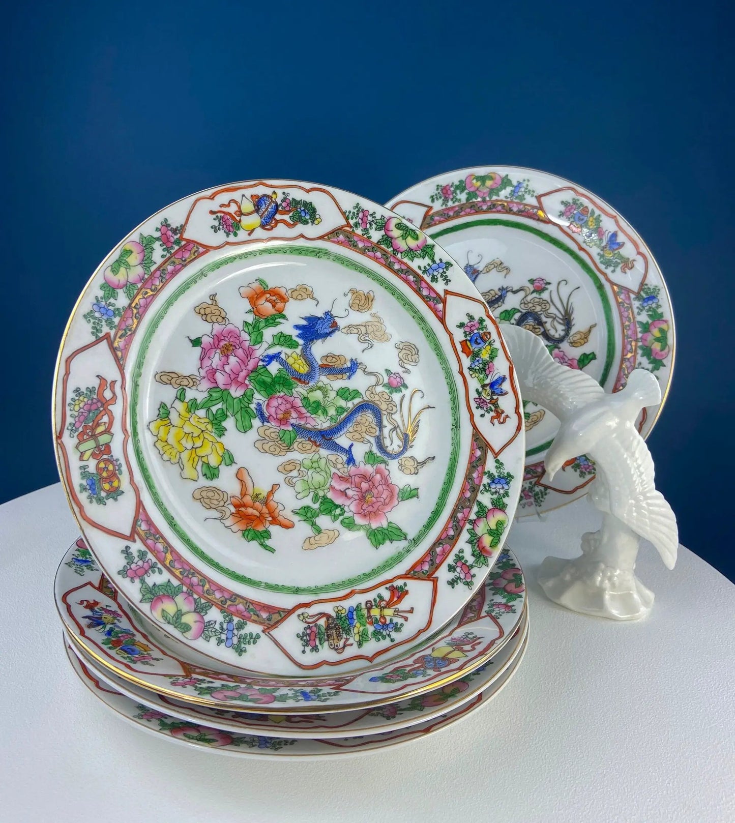 Five large Asian porcelain plates featuring dragons and peonies with colorful borders on Tampa Home & Garden Store