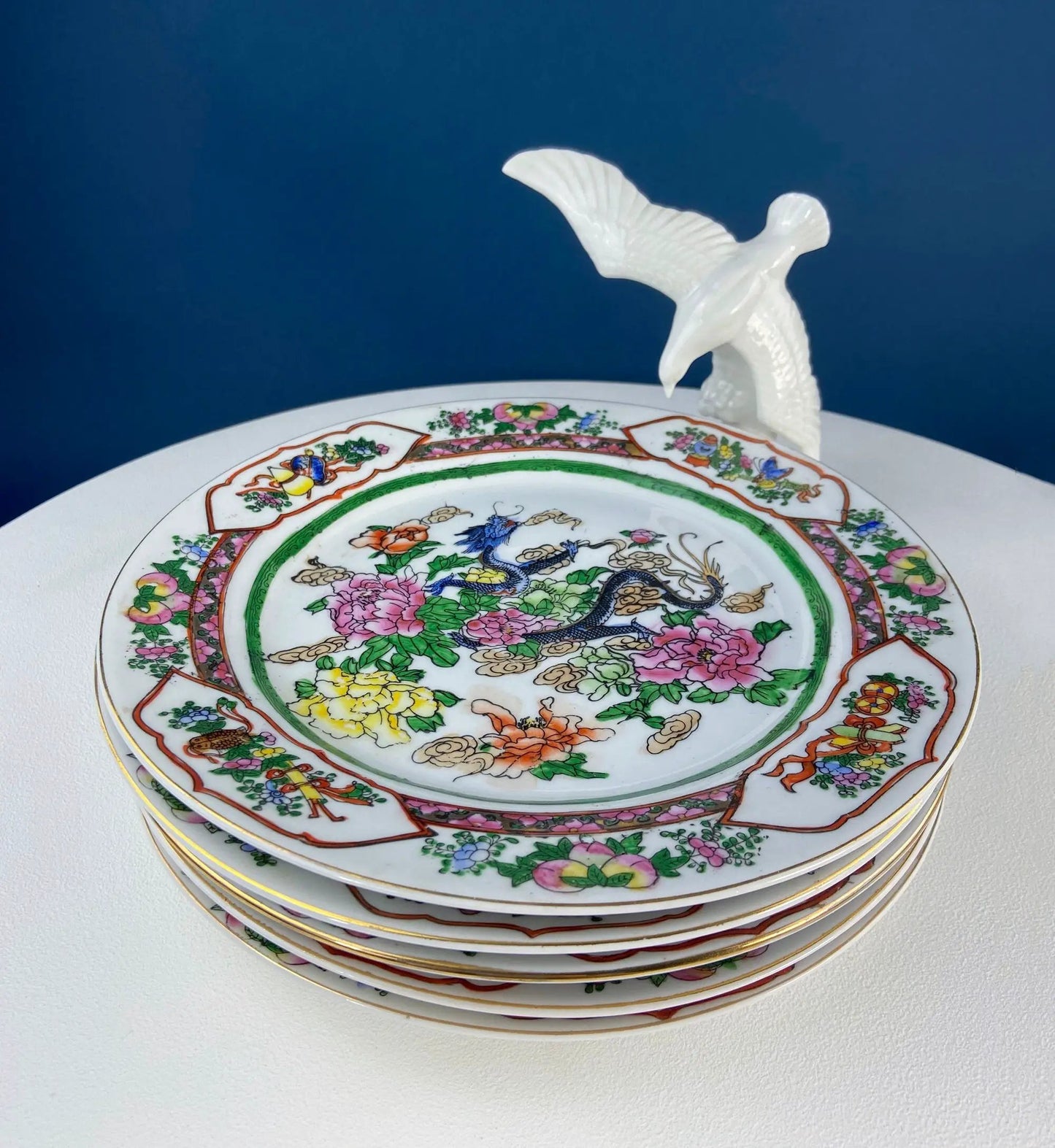 Five large porcelain Asian plates with dragon and peony motifs, stacked on Tampa Home & Garden Store