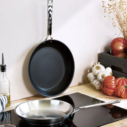 CRISTEL USA 2-piece frying pans set, black nonstick skillets with long handles, one hanging above stove on Tampa Home & Garden Store