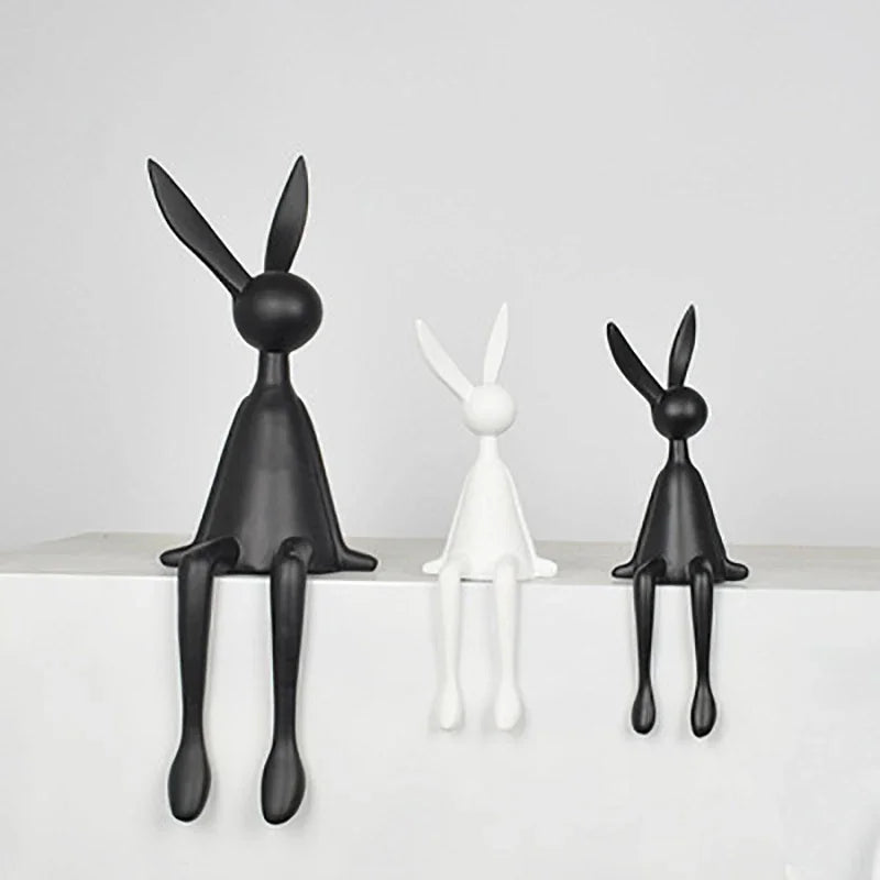 Abstract rabbit statue trio by Perfecsy: two black, one white lounging figurines for decor on Tampa Home & Garden Store