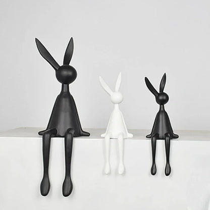 Abstract rabbit statue trio by Perfecsy: two black, one white lounging figurines for decor on Tampa Home & Garden Store