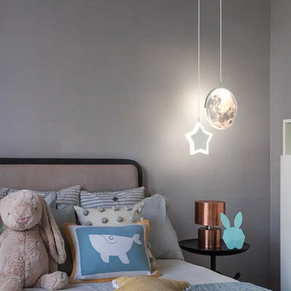DecorBites Kids Star Moon Pendant Lamp with remote dimming over a cozy bed on Tampa Home & Garden Store