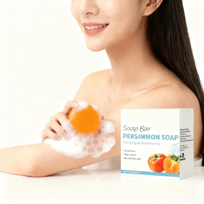 Persimmon Soap Bar by Silcy Skin, orange soap with foamy lather held by a smiling model on Tampa Home & Garden Store
