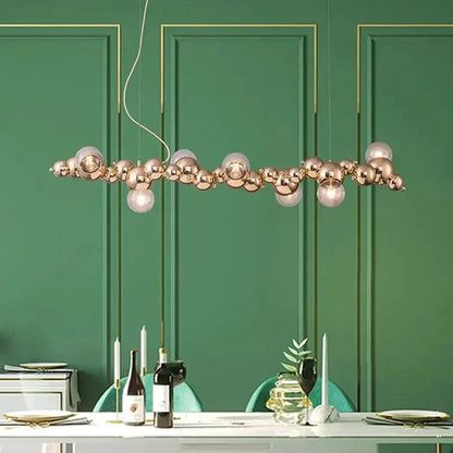 DecorBites LED pendant chandelier with gold globe spheres and glass bulbs over a dining table on Tampa Home & Garden Store