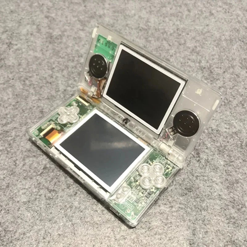 Clear plastic handheld game console shell with dual screens, exposed PCB and round speakers on Tampa Home & Garden Store