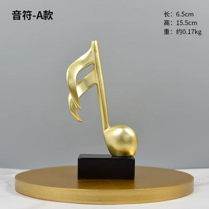 Golden musical note sculpture on round gold base with black stand, modern decor on Tampa Home & Garden Store