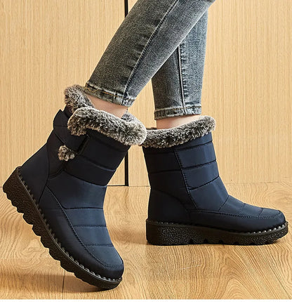 Women's navy waterproof winter boots with faux fur trim and chunky lug sole; 2 boots shown on Tampa Home & Garden Store