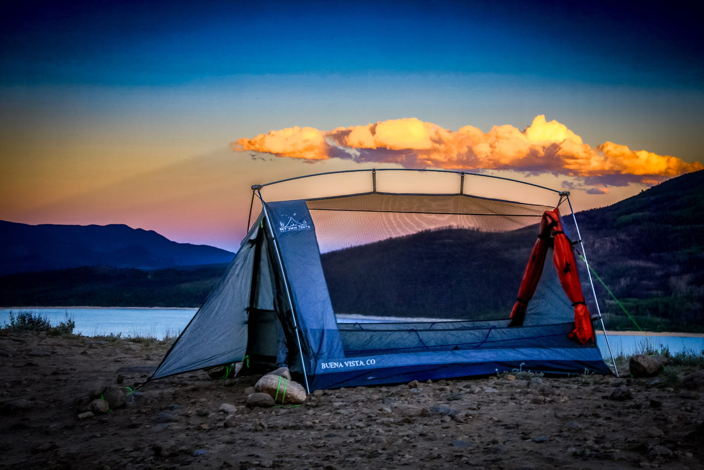 Sky View Solo Tent by Sky View Tents, blue camping shelter with arch frame at sunset over a lake on Tampa Home & Garden Store