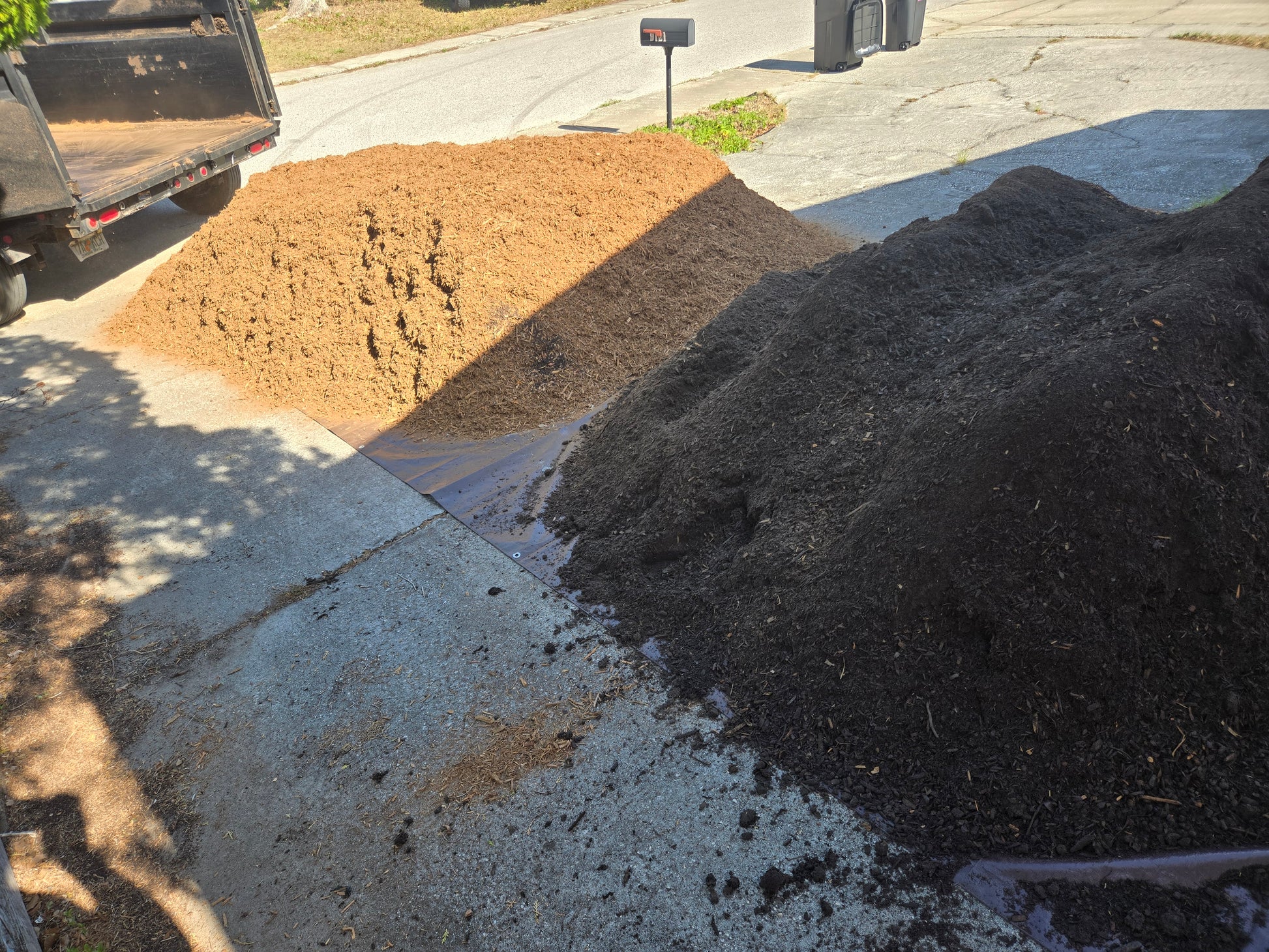 Soil and mulch delivery executed in one trip and dumped in separate piles.