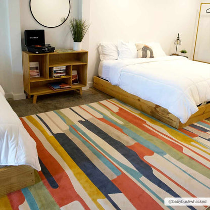 Southfields Colorful Modern Area Rug with striped pattern in a bedroom by Boutique Rugs on Tampa Home & Garden Store