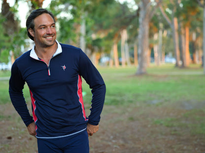 Southport athletic shirt navy with red panels by White Water Life worn by man in park on Tampa Home & Garden Store