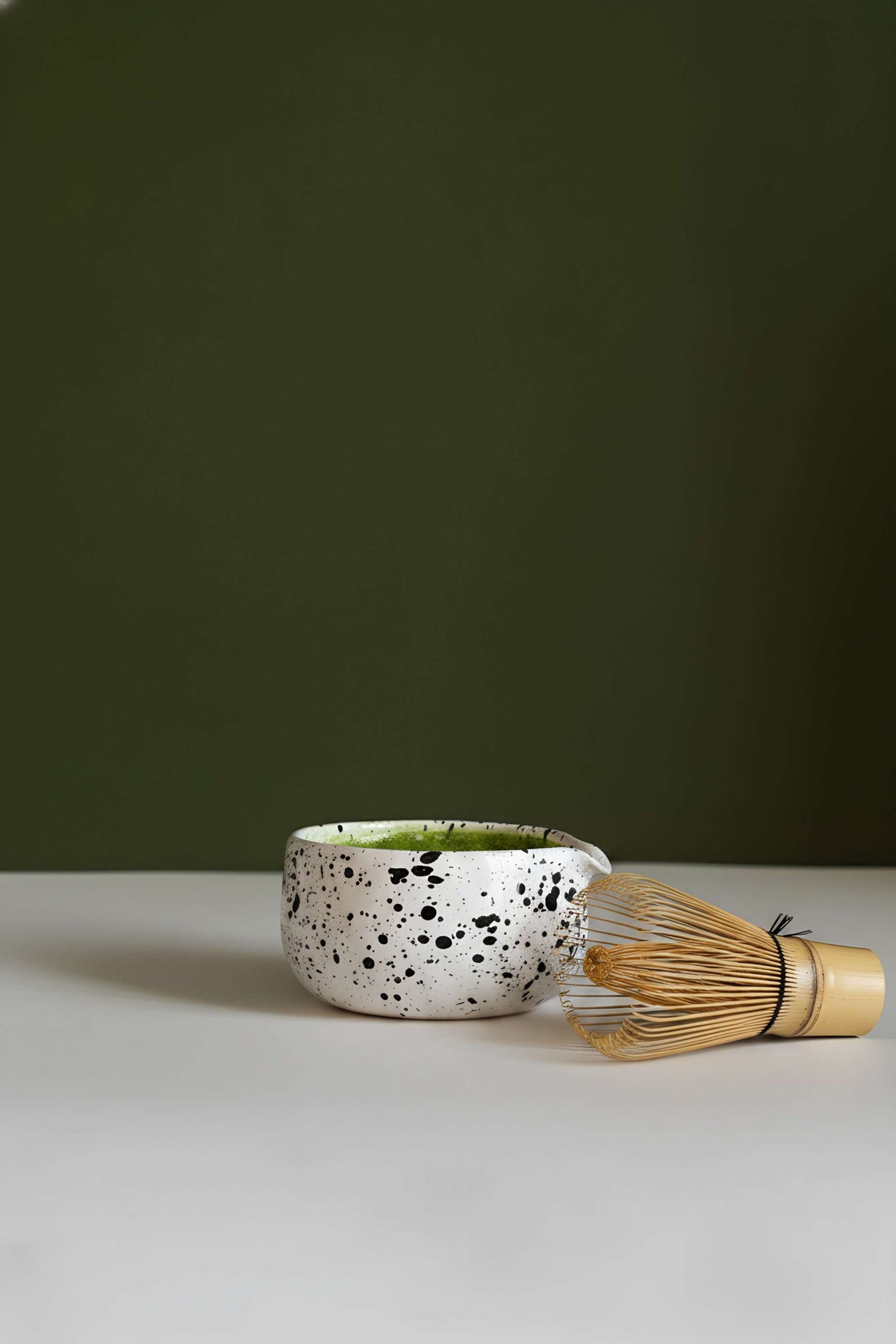Handmade matcha bowl with white speckled glaze and green interior with bamboo whisk 2-piece set on Tampa Home & Garden Store