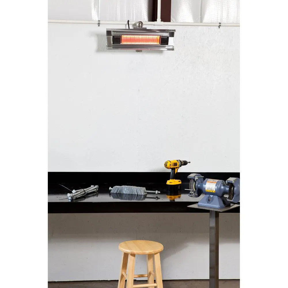 Stainless steel wall-mounted infrared patio heater by Fire Sense/Balkene Home, glowing orange above a workshop bench with drill and grinder on Tampa Home & Garden Store