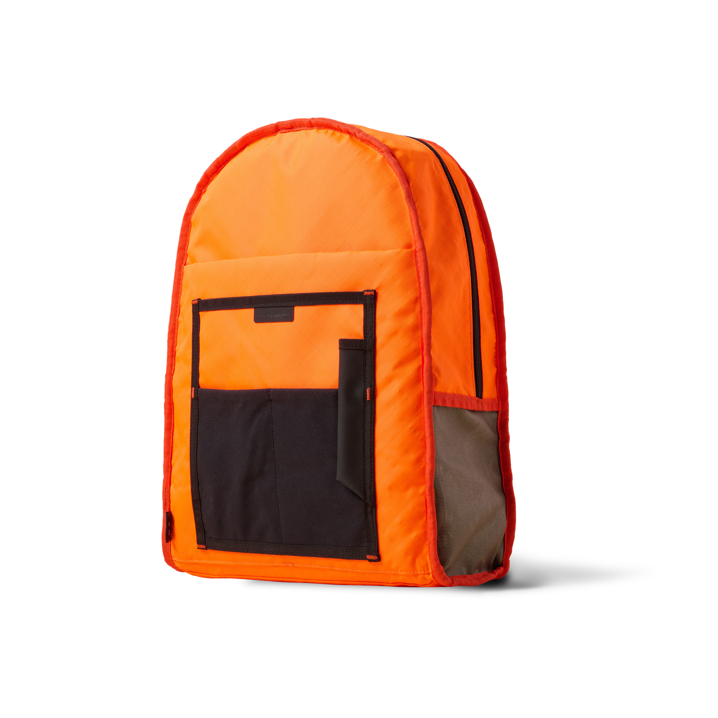 Standard Issue backpack by The Brown Buffalo in orange with black front pocket on Tampa Home & Garden Store