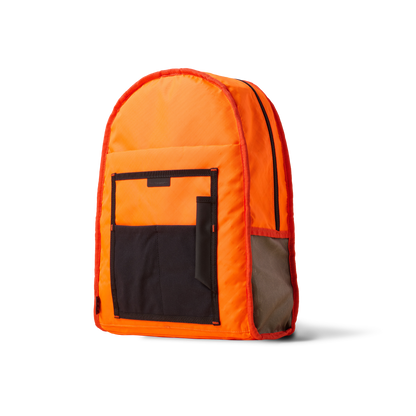 Standard Issue backpack by The Brown Buffalo in orange with black front pocket on Tampa Home & Garden Store