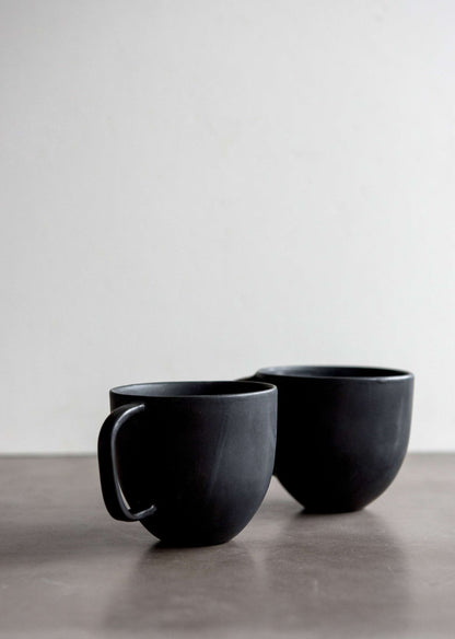 Black matte stoneware coffee mug set of two with curved handles on a neutral surface on Tampa Home & Garden Store