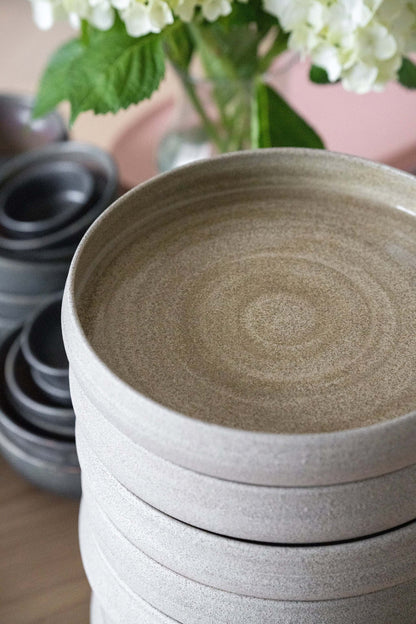 Stack of 3 stoneware dinner plates with high sides in concrete gray, close-up on Tampa Home & Garden Store