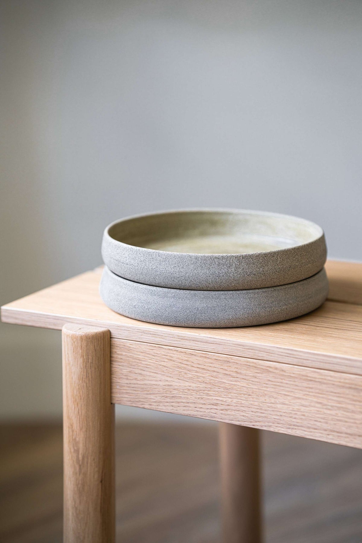 Stoneware salad plates 2 with high sides Concrete gray by Creating Comfort, stacked on Tampa Home & Garden Store