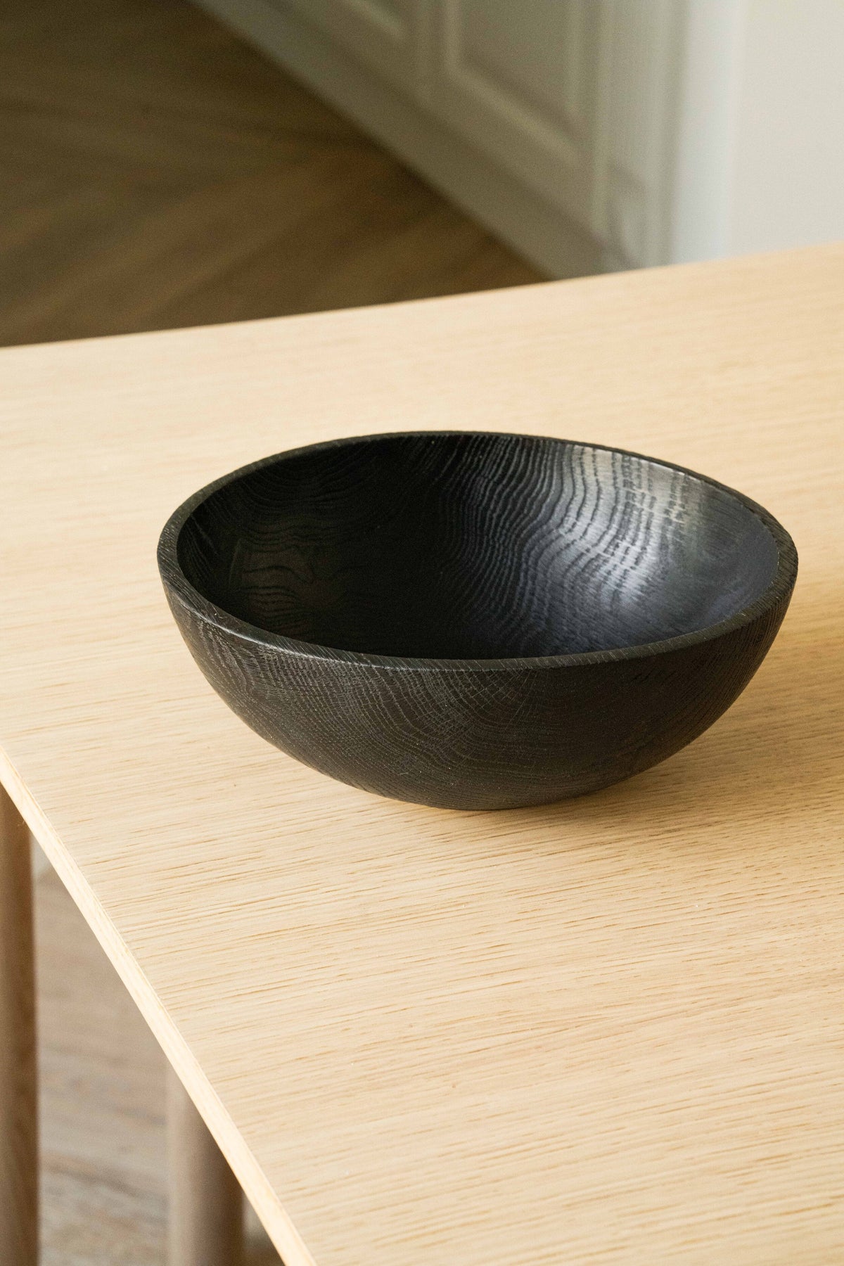 Hand-carved large charred black wood bowl by CREATING COMFORT on a light wooden table on Tampa Home & Garden Store