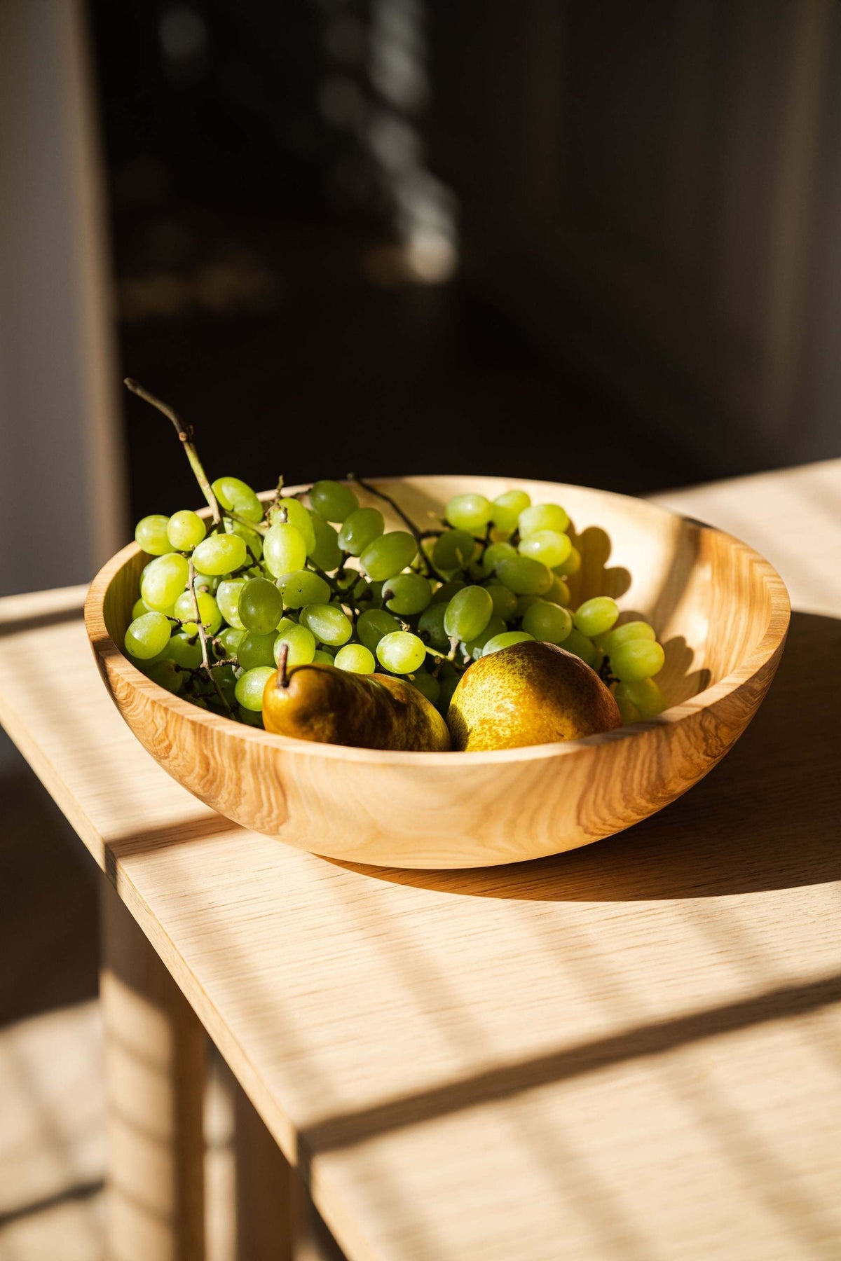 Hand Carved Wooden Nesting Bowl Set in natural wood grain with green grapes and pears on Tampa Home & Garden Store