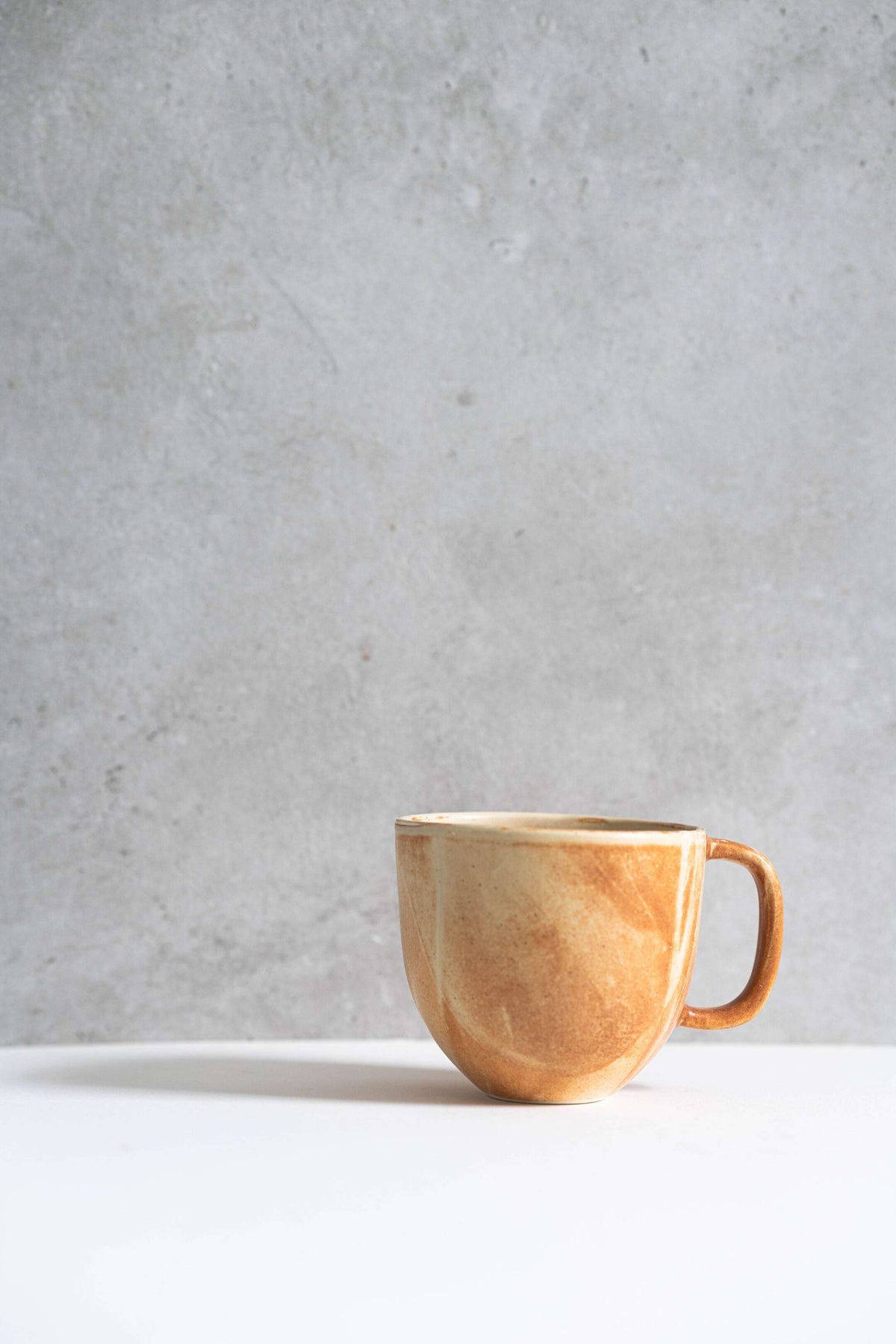 Stoneware beige coffee mug by Creating Comfort with a warm glazed finish and curved handle on Tampa Home & Garden Store