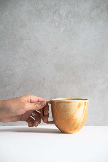 Stoneware beige coffee mug by Creating Comfort with a brown handle, warm glossy glaze on Tampa Home & Garden Store