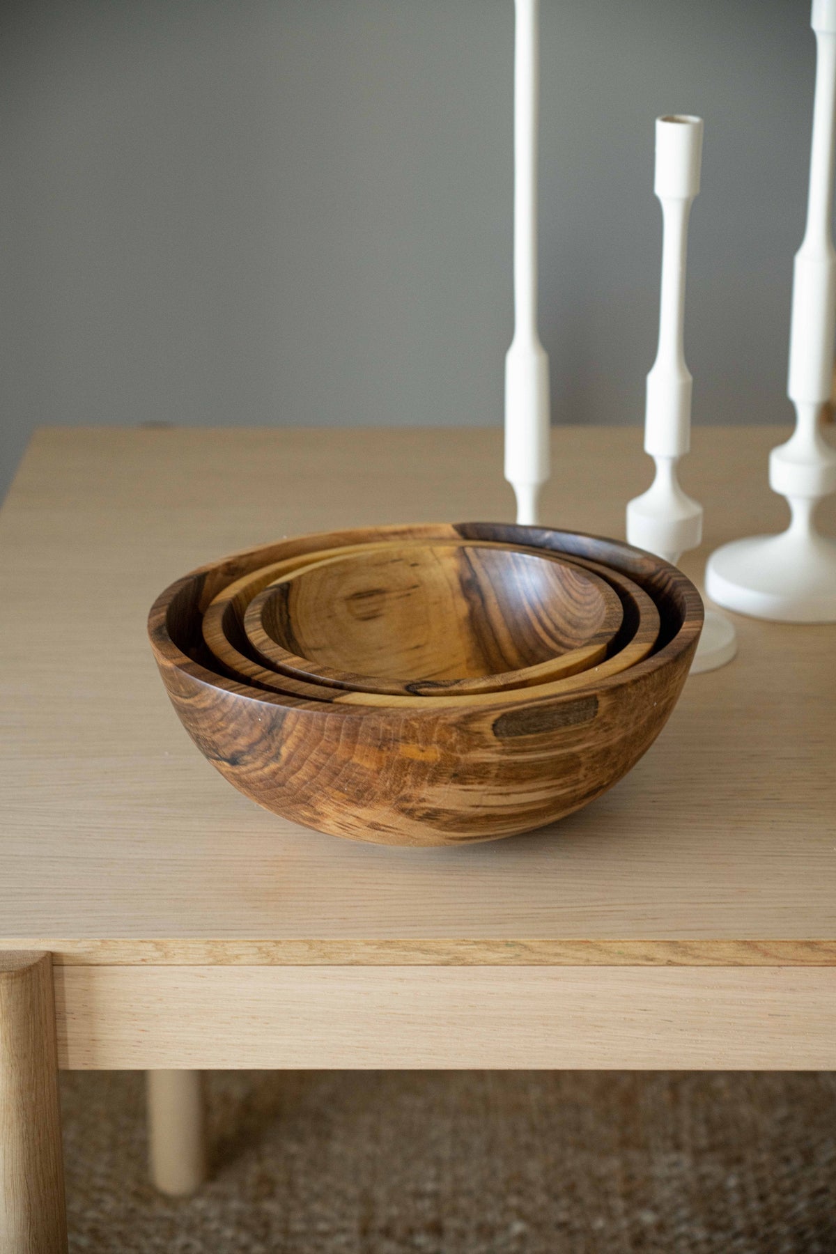 Hand carved walnut nesting bowls set of 3 on a light wood table with candlesticks on Tampa Home & Garden Store