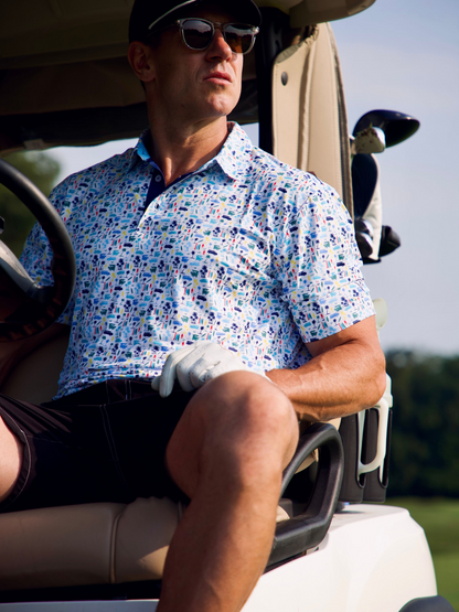 Surfs Up Performance Polo by White Water Life, light blue polo with palm trees on Tampa Home & Garden Store