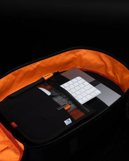 Conceal Pack 21L backpack with orange lining and laptop inside on Tampa Home & Garden Store