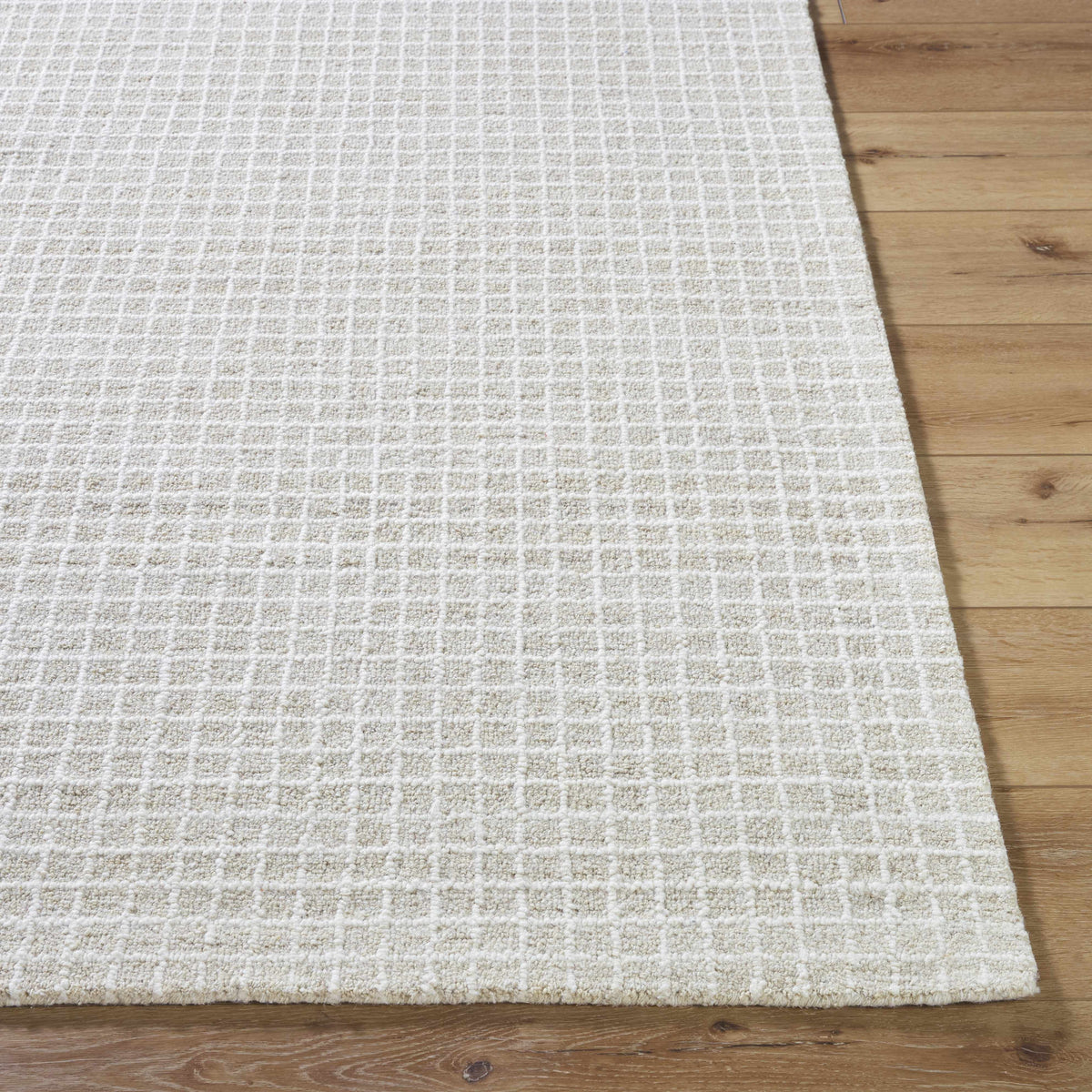 Anahid Bone Area Rug by Boutique Rugs in bone color with grid texture on wood floor on Tampa Home & Garden Store