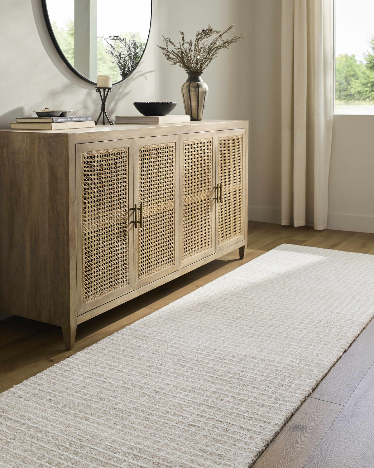 Anahid Bone Area Rug by Boutique Rugs, ivory beige textured pile under a light wood sideboard on Tampa Home & Garden Store