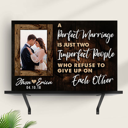 Canvas sign by Tailored Canvases with dark wood backdrop and couple portrait inset on Tampa Home & Garden Store