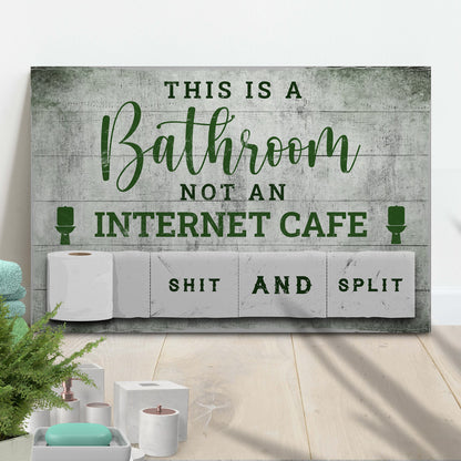 Canvas sign This Is A Bathroom Not An Internet Cafe with gray wood backdrop and green typography on Tampa Home & Garden Store