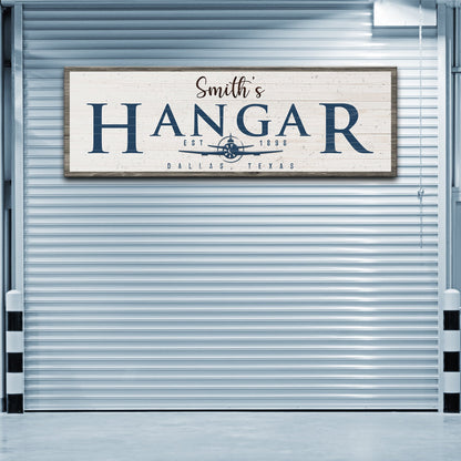 Hangar sign canvas by Tailored Canvases navy HANGAR lettering with plane emblem on planks on Tampa Home & Garden Store