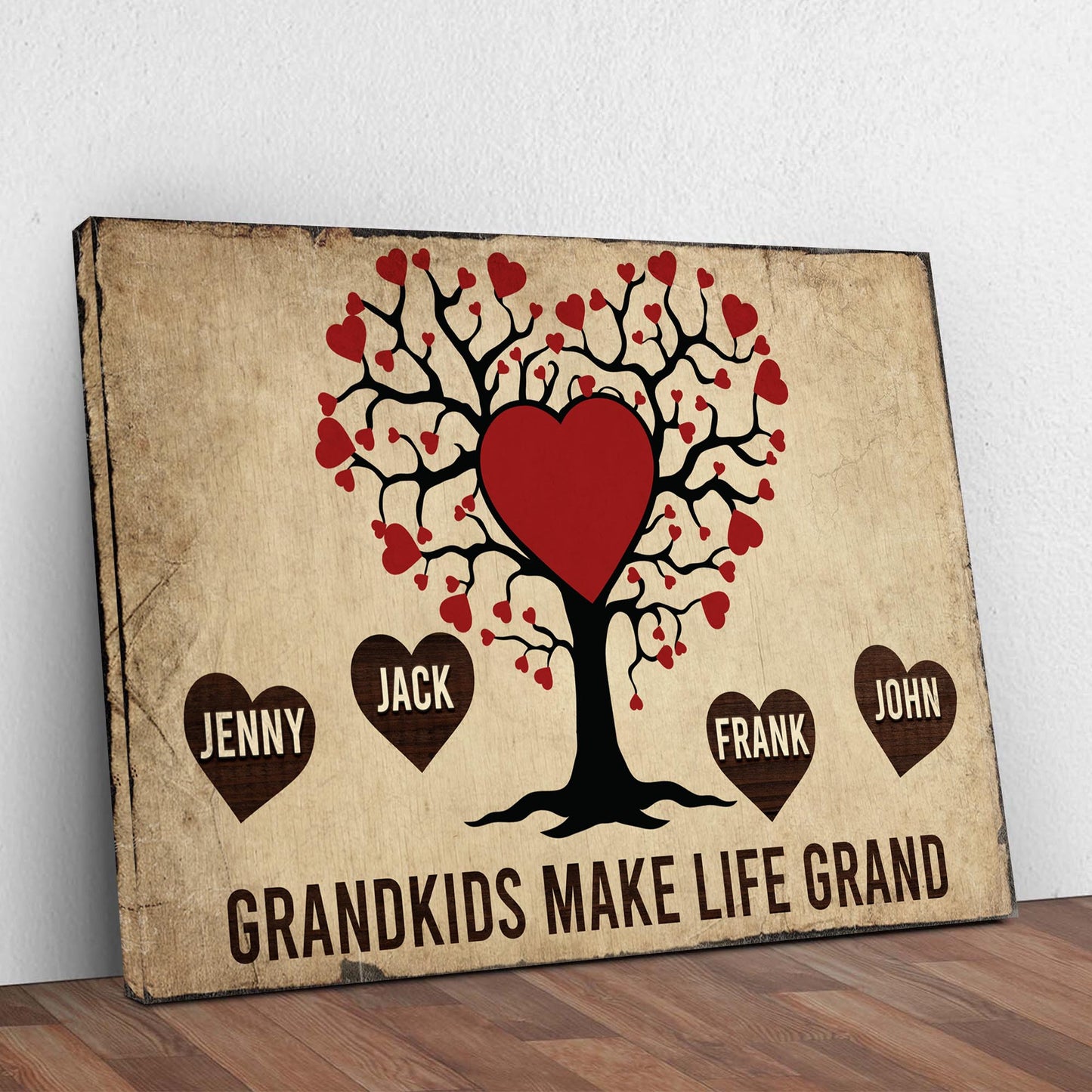 Grandkids Make Life Grand canvas sign featuring a black heart tree and red hearts on parchment on Tampa Home & Garden Store