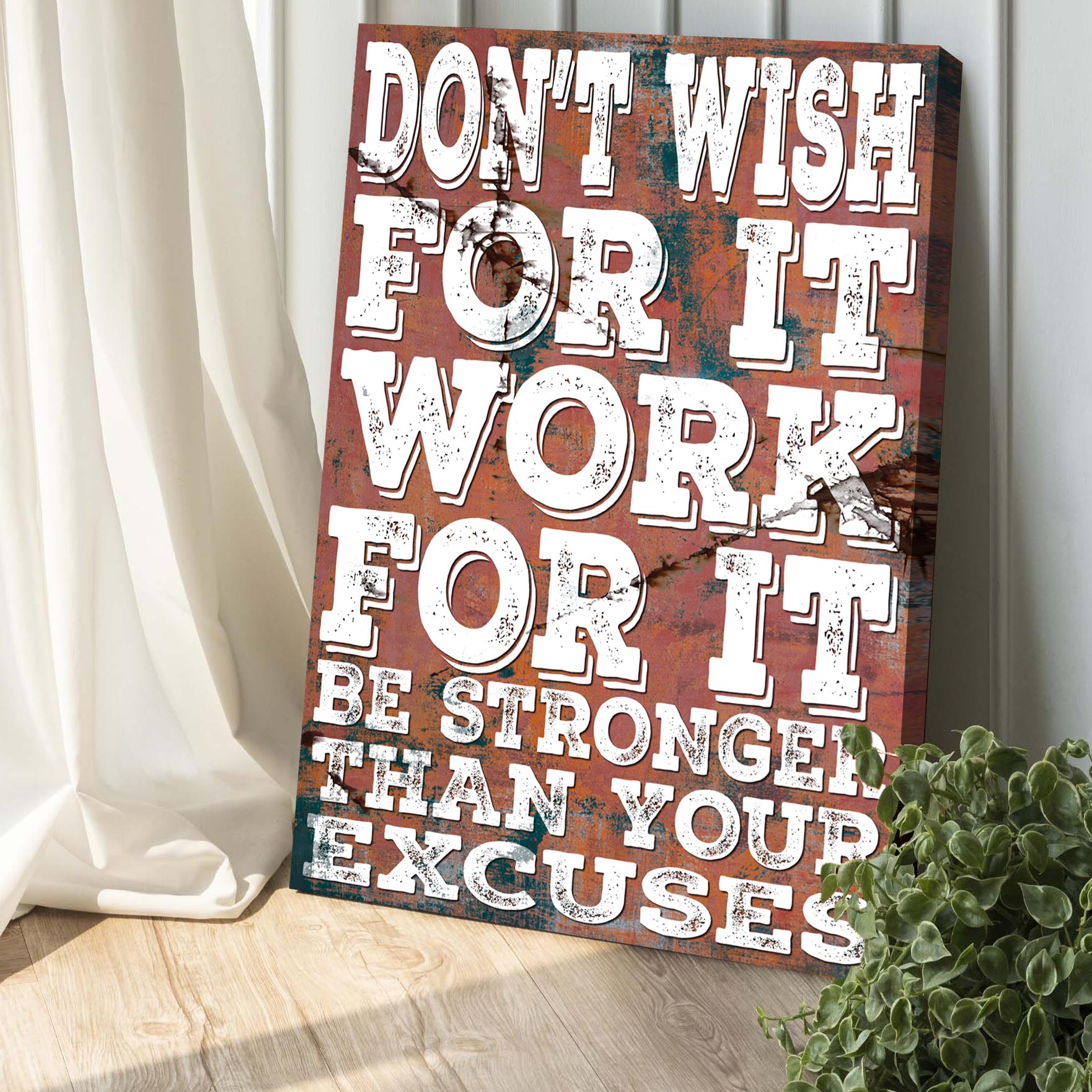 Canvas sign Tailored Canvases Don't Wish For It II with distressed white lettering on rust on Tampa Home & Garden Store