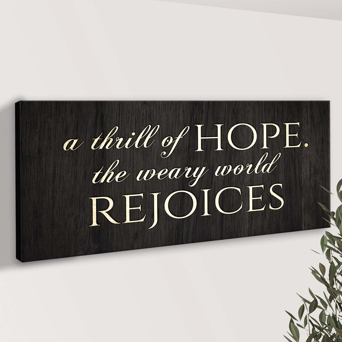 Canvas sign with woodgrain and ivory script reading A Thrill Of Hope The Weary World Rejoices on Tampa Home & Garden Store