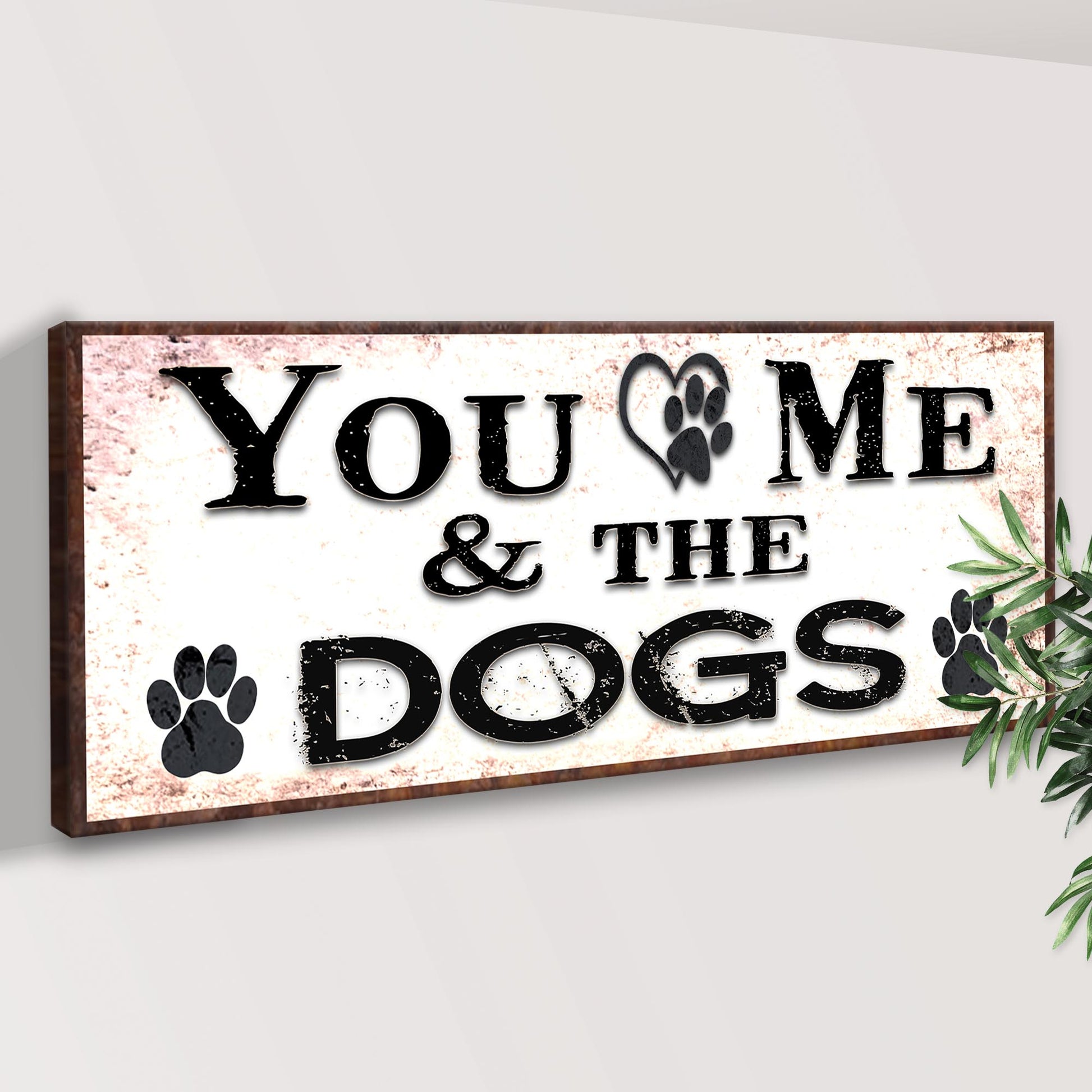 Canvas sign You & Me & The Dogs with paw print, distressed black lettering, brown frame on Tampa Home & Garden Store