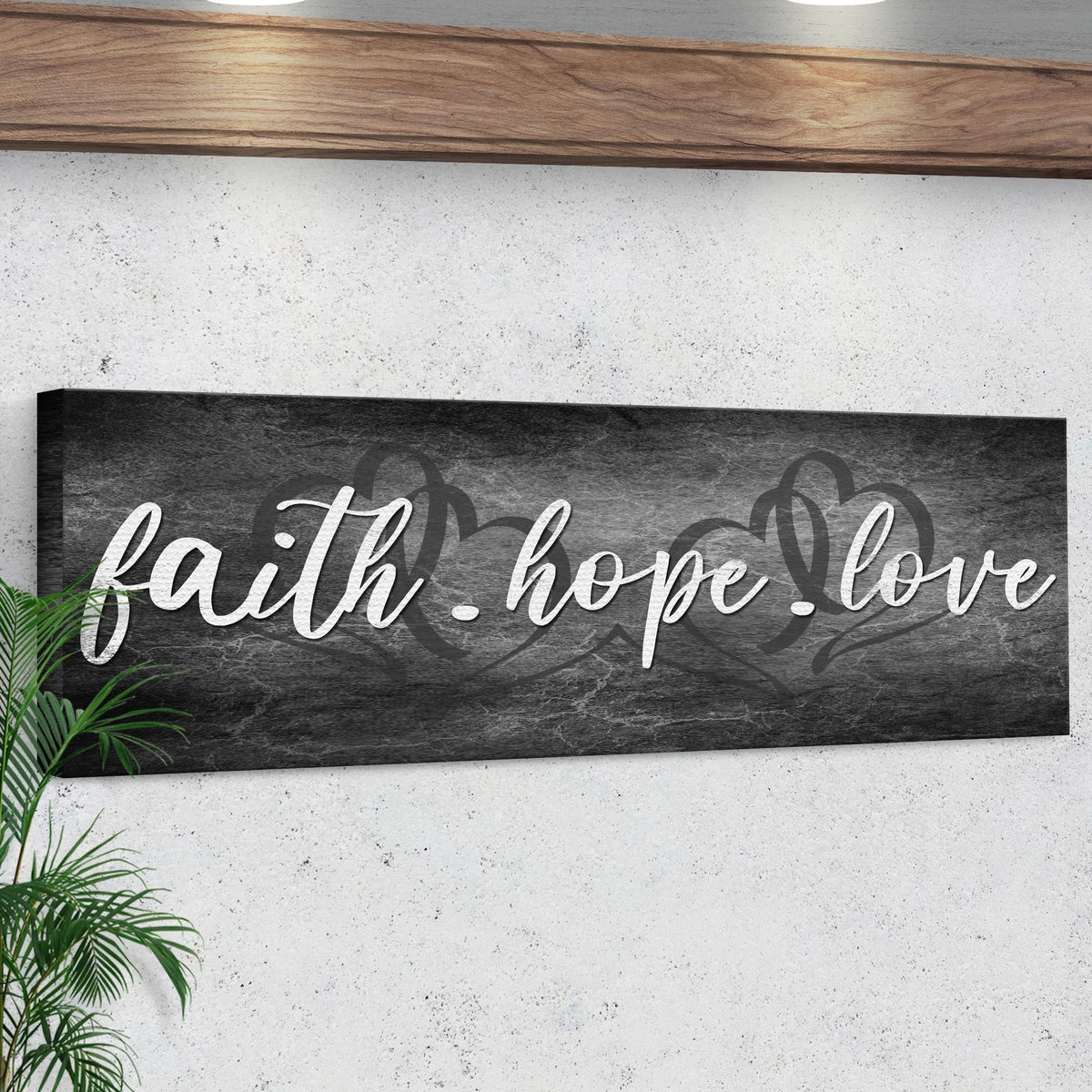Faith, Hope, and Love canvas sign with white cursive lettering on dark gray textured canvas on Tampa Home & Garden Store