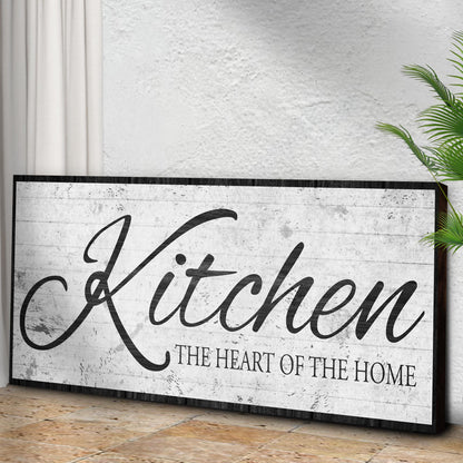 Kitchen Is The Heart Of The Home Sign II canvas by Tailored Canvases on a rustic textured board with a green plant