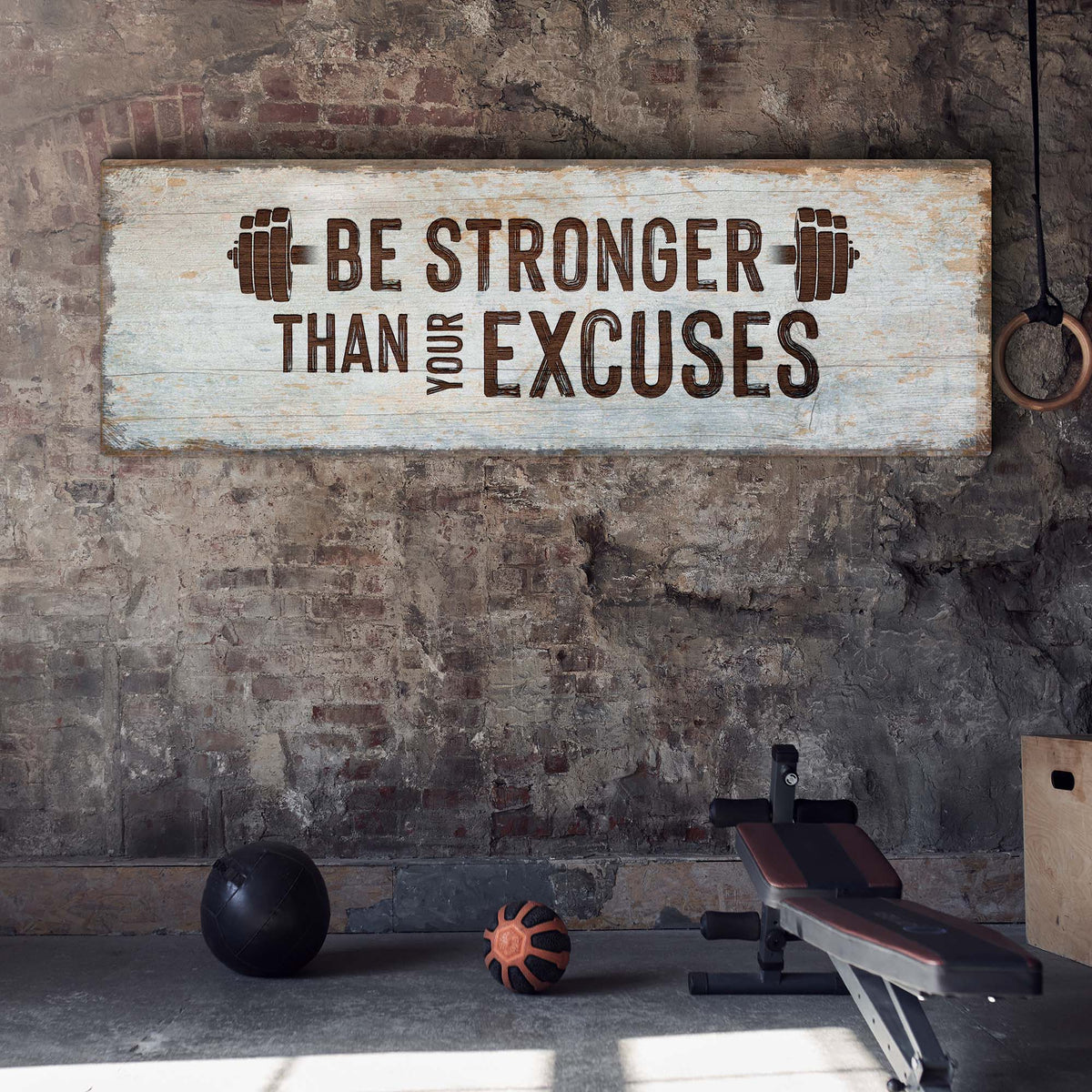 Be Stronger Than Your Excuses Sign II canvas with brown bold lettering and weight icons on a rustic whitewashed wood plank Tailored Canvases on Tampa Home & Garden Store