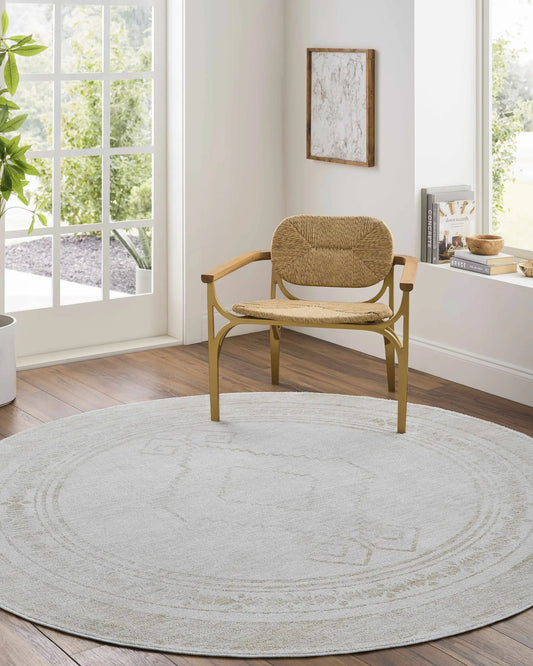 Taban Luxe Rug by Boutique Rugs, cream rug with pattern in bright room and a rattan chair on Tampa Home & Garden Store