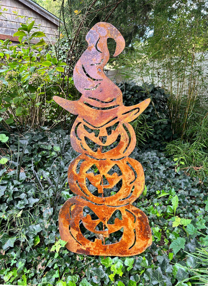 Three stacked pumpkin metal sculpture in rusty orange with cutout faces Rustica Ornamentals decor on Tampa Home & Garden Store