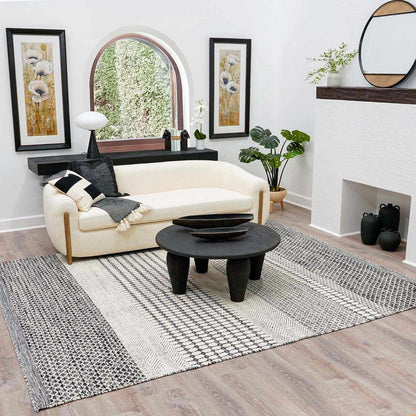 Tideswell Scandi Boho Wool Carpet cream/charcoal woven rug by Boutique Rugs in a cozy living room on Tampa Home & Garden Store