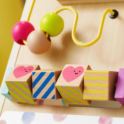 Tiny Land Premium Natural Wooden Activity Walker with colorful beads on a yellow wire and heart-patterned wooden blocks on Tampa Home & Garden Store