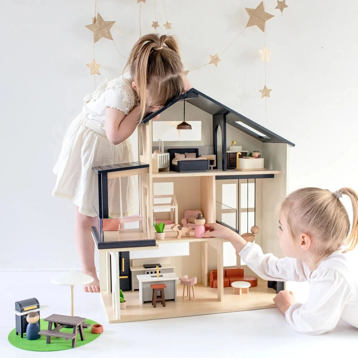 Tiny Land Sweetwood Edge Dollhouse by Tiny Land INC, wooden dollhouse with black trim, two kids on Tampa Home & Garden Store
