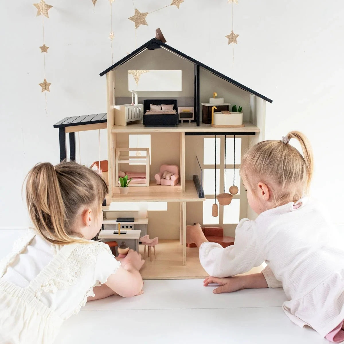 Tiny Land Sweetwood Edge Dollhouse with multi-room interior and miniature furniture; children playing on Tampa Home & Garden Store
